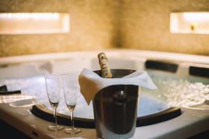 a bottle of champagne in a bucket on a table with wine glasses at Petriti & Spa in Ulcinj