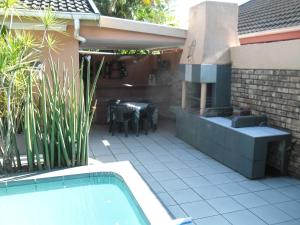 a patio with a table and a swimming pool at 57 Pelican Street in St Lucia