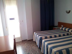Cama ou camas em um quarto em Hotel Costa San Antonio