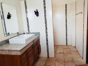 a bathroom with a sink and a mirror at Mina Garden Villa Resort in Chiang Mai