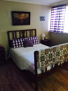 a bedroom with a bed with a blanket on it at Beautiful Retreat by the Beach - 1 Lecaille Court in Dunsborough