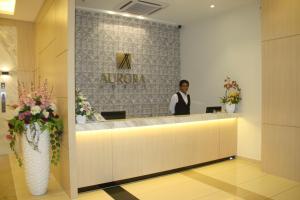 Členové personálu v ubytování Aurora Hotel
