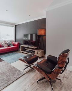 a living room with a chair and a couch at Ski-in, Ski-out Hatsuyuki Apartments in Hakuba