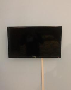 a flat screen tv hanging on a wall at Hotel Malaga in Avellino