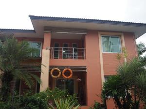 a house with two orange rings on it at BAANTAI HOMESTAY in Chumphon
