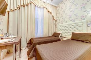 a hotel room with two beds and a sink at Guest rooms on Marata 10 in Saint Petersburg