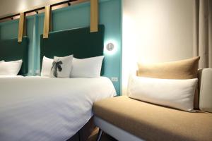Postel nebo postele na pokoji v ubytování Hai Sheng Wei B&B