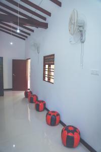 a room with a row of red spheres on the floor at Hikka Surf Hostel in Hikkaduwa