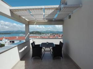 a balcony with a table and chairs and a view at Apartments Marti in Murter