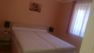 Posteľ alebo postele v izbe v ubytovaní Balaton Apartman
