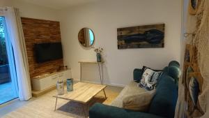a living room with a couch and a table at Au gré des marées in Roscoff