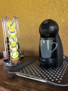 a black coffee maker sitting on top of a table at B&B La Cerisaie in Francheleins