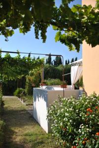 a garden with a white fence and some flowers at Residenza agrituristica Santa Lucia con piscina in Alghero +31 photos