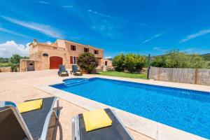 eine Villa mit einem Pool vor einem Haus in der Unterkunft Villa SES COMES in Manacor