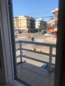 a view of a city street from a balcony at TRES TORRES POUSADA in Torres +1 photo