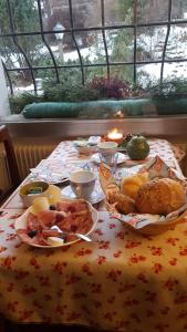 a table topped with plates of food on a table at Country House Dolomiti in Ortisei