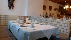 a table with a white table cloth on it at Gästehaus Alpenland in Tux