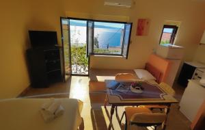a living room with a couch and a table and chairs at Apartments Niko in Omiš