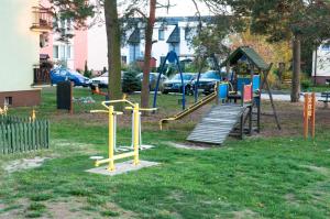 a playground with a slide in a park at Apartament Gosia in Rogowo