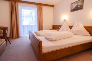 Posteľ alebo postele v izbe v ubytovaní Berghotel Rasis