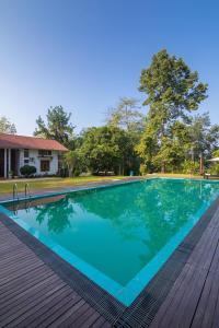 a swimming pool on a wooden deck at Estancia Holiday Bungalow in Matale