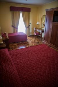 Postel nebo postele na pokoji v ubytování Albergo Ristorante Uliveto