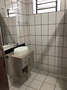 a bathroom with a sink and a mirror at Casa para temporada in Governador Celso Ramos +34 photos