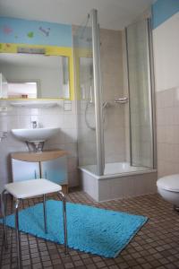 a bathroom with a sink and a shower and a toilet at Donau Pension in Tuttlingen