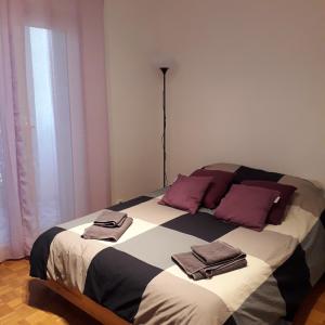 a bedroom with a large bed with towels on it at Les Pins . 2 p calme et terrasse in Nice