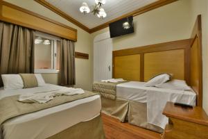 Tempat tidur dalam kamar di Hotel Pequeno Bosque