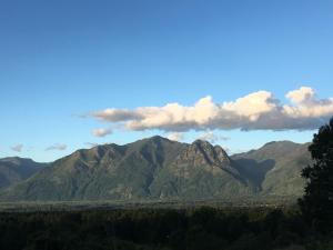 a view of a mountain range with clouds in the sky at Tiny House con Tinaja Privada en Pucón in Pucón