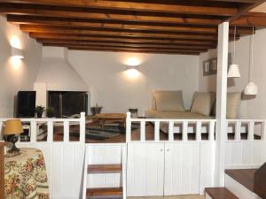 a living room with a bed and a table at Villa Smaragdi-Despoina in Malona Village
