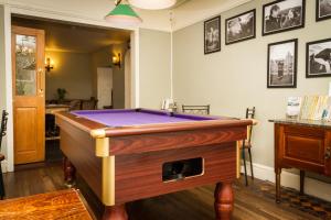 a room with a pool table with purple at Woolpack Inn in Eskdale
