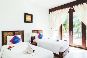 Giường trong phòng chung tại Lotus Muine Resort & Spa