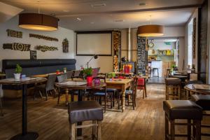 a restaurant with tables and chairs and a chalkboard at Woolpack Inn in Eskdale