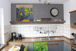 a kitchen with a sink and a clock on the wall at Happy Homes in Haiger in Haiger