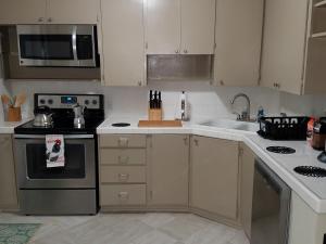 a kitchen with a sink and a stove top oven at Hist Two Bedroom Home in Avondale Riverside Jacksonville in Jacksonville