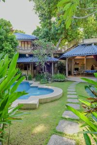 a house with a swimming pool in the yard at Ben Bali Villa in Seminyak