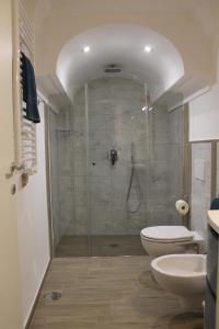 a bathroom with a shower with a toilet and a sink at La Casetta di Anna in Capri +44 photos