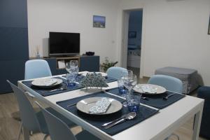 a dining room table with plates and glasses on it at La Casetta di Anna in Capri
