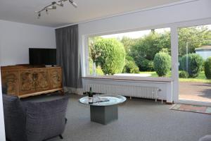 a living room with a large window and a table at Happy Homes in Haiger in Haiger