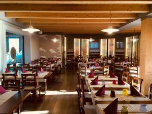 une salle à manger avec des tables et des chaises dans un restaurant dans l'établissement Il Paradello Albergo, à Porto Levante
