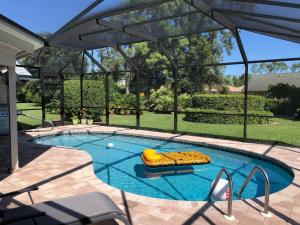 a swimming pool with a raft and an inflatable at VILLA BELLY in Naples in Naples