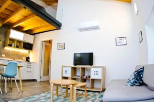 a living room with a couch and a table and a kitchen at Casas S Cristovao in Évora