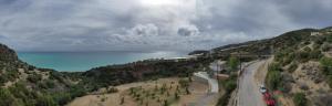a view of a road on a hill with the ocean at Skouros Villa in Kastrí