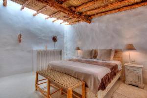 a bedroom with a bed and a chair in it at Can Quince de Balafia - Turismo de Interior in Sant Llorenç de Balafia