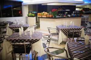 a restaurant with tables and chairs in a room at Hotel San José Plaza in Bucaramanga