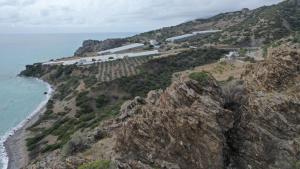an aerial view of a mountain next to the ocean at Skouros Villa in Kastrí