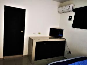 a room with a door and a desk with a computer on it at Mi Depa Tec 5 in Monterrey