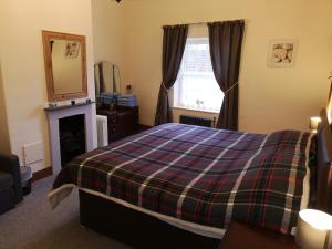 Ένα ή περισσότερα κρεβάτια σε δωμάτιο στο Pathways Cottage